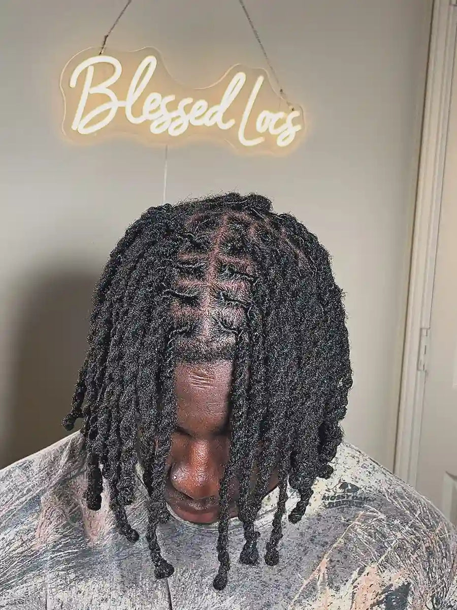 Short black starter locs styled in chunky two-strand twists with neat square parting, Stylist located in Bowling Green, KY