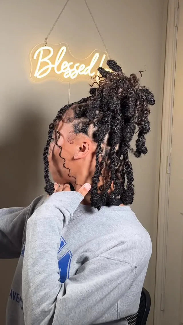 Shoulder-length black curly loc bob with a center part and textured curly ends, Stylist located in Bowling Green, KY