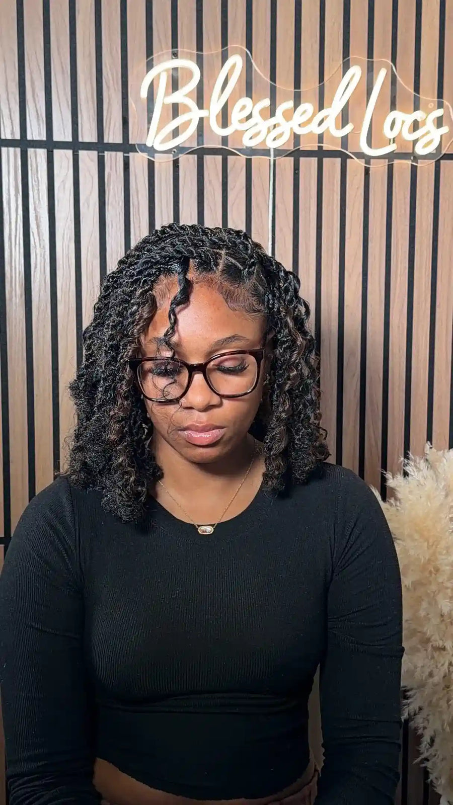 Shoulder-length black curly locs with defined spiral curls and face-framing strands, Stylist located in Bowling Green, KY