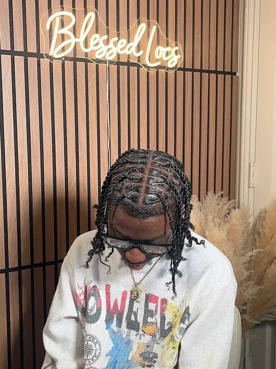 Short black two-strand twisted locs with clean center parting and curly ends, Stylist located in Bowling Green, KY