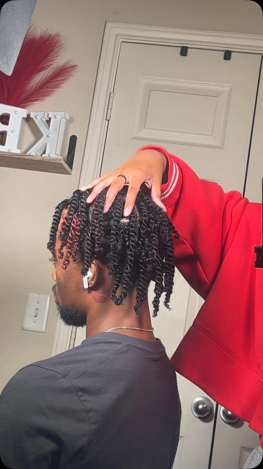 Short black two-strand twist locs with burgundy highlights and defined curly ends, Stylist located in Bowling Green, KY