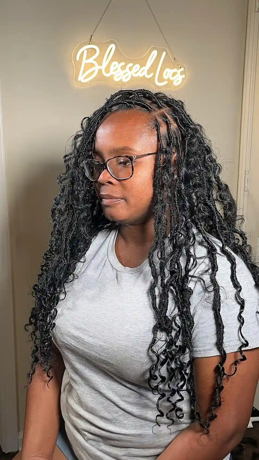 Shoulder-length brown curly locs with neat square parting and defined spiral curls, Stylist located in Bowling Green, KY