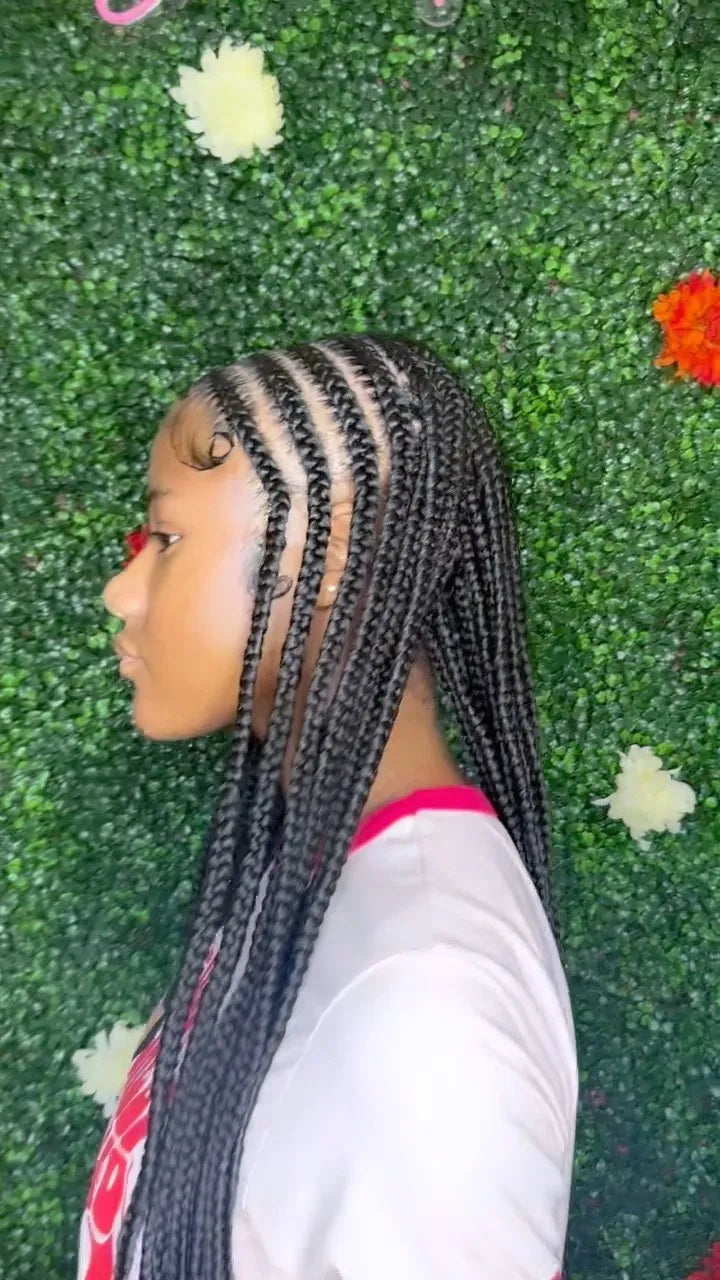 Person with braided hair against a green textured background