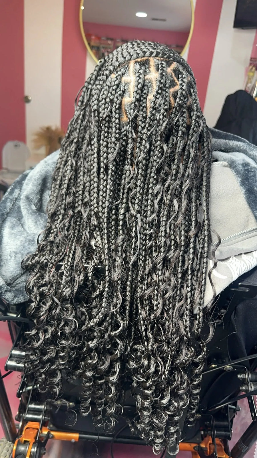 Person with braided hair in a salon setting