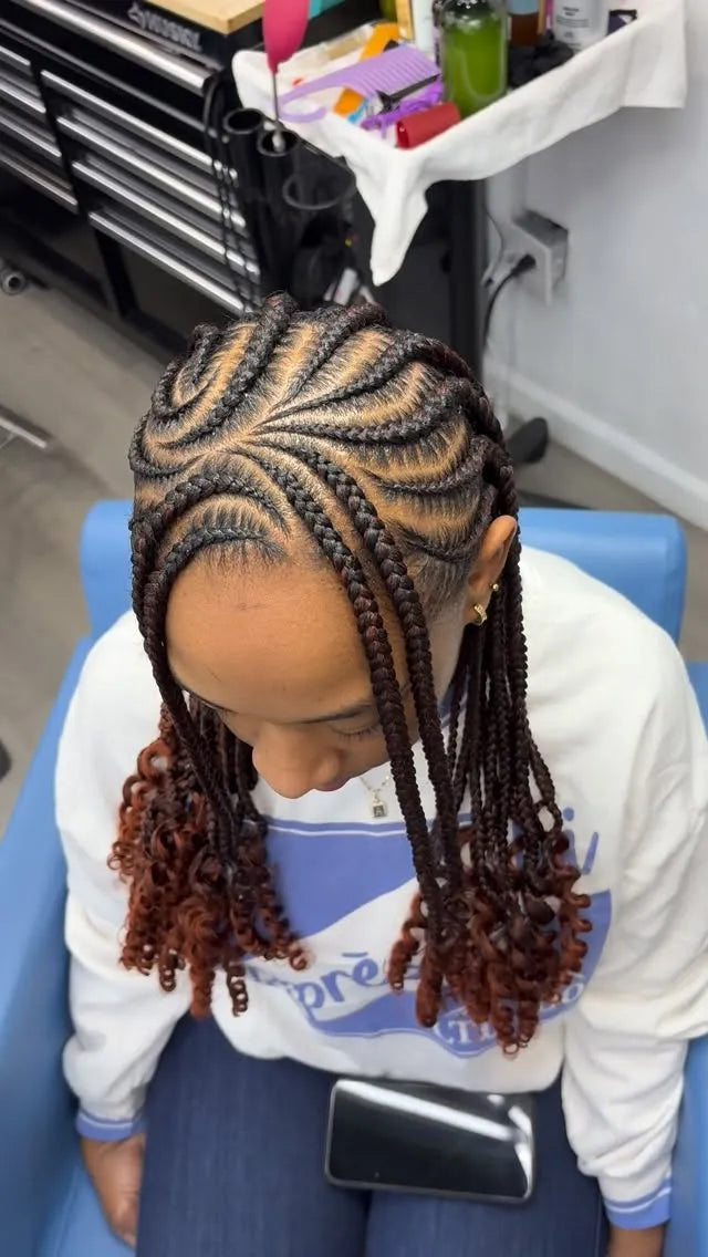 Intricate stitch cornrows with a braided swirl design and long side-swept box braids, hairstylist located in Wilkes-Barre, PA