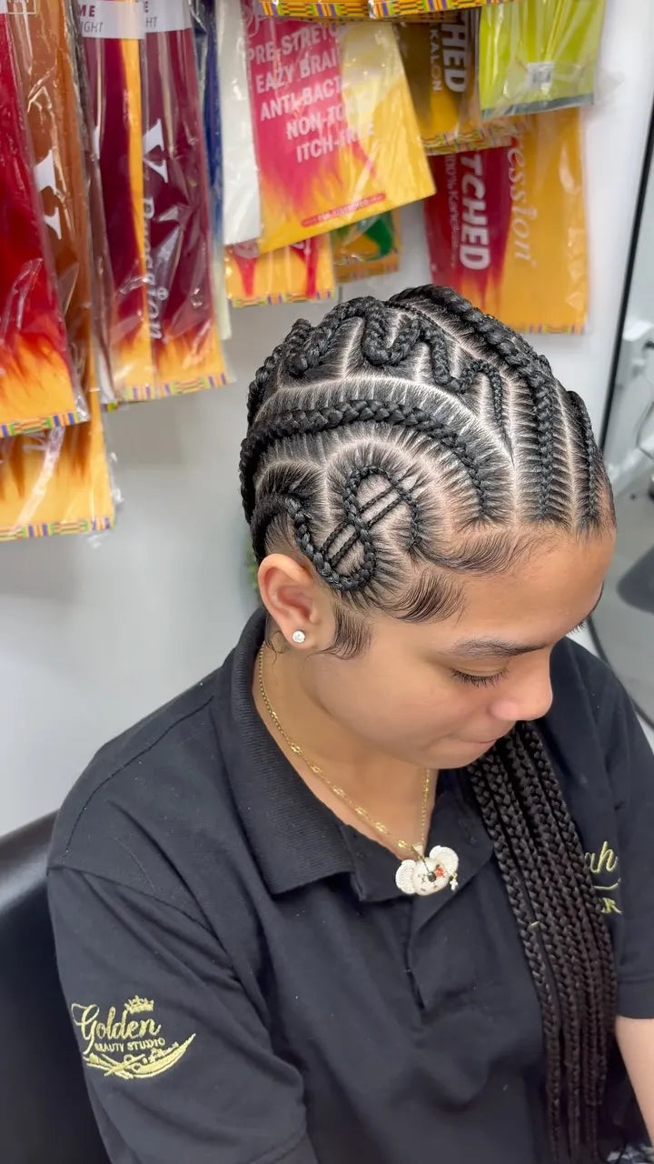 Creative cornrows with a braided heart design and two long braids, hairstylist located in Wilkes-Barre, PA