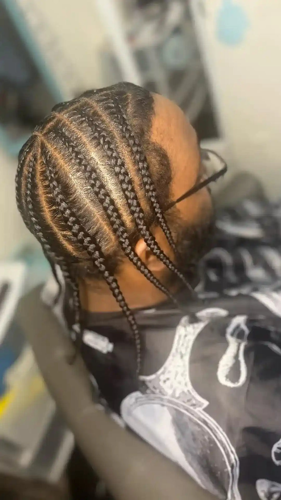 Men’s straight-back cornrows with clean curved parting and small accent braids, hairstylist located in Bettendorf, IA