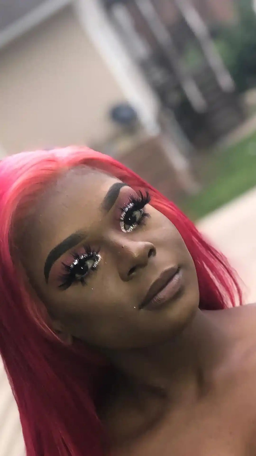 Sleek straight bright pink hairstyle with a deep side part, hairstylist located in Bettendorf, IA