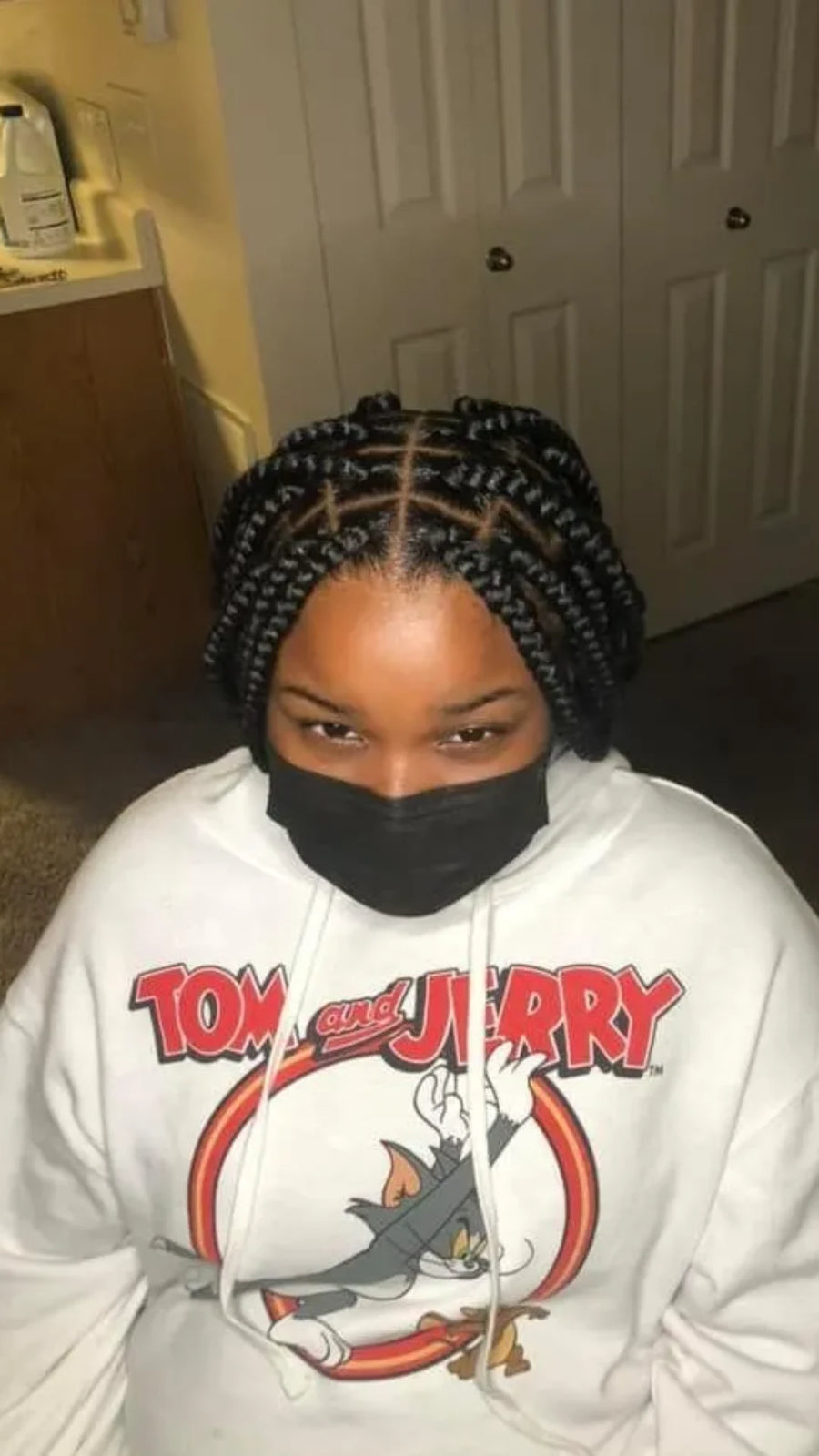 Short jumbo knotless box braid bob with a center part, hairstylist located in Bettendorf, IA