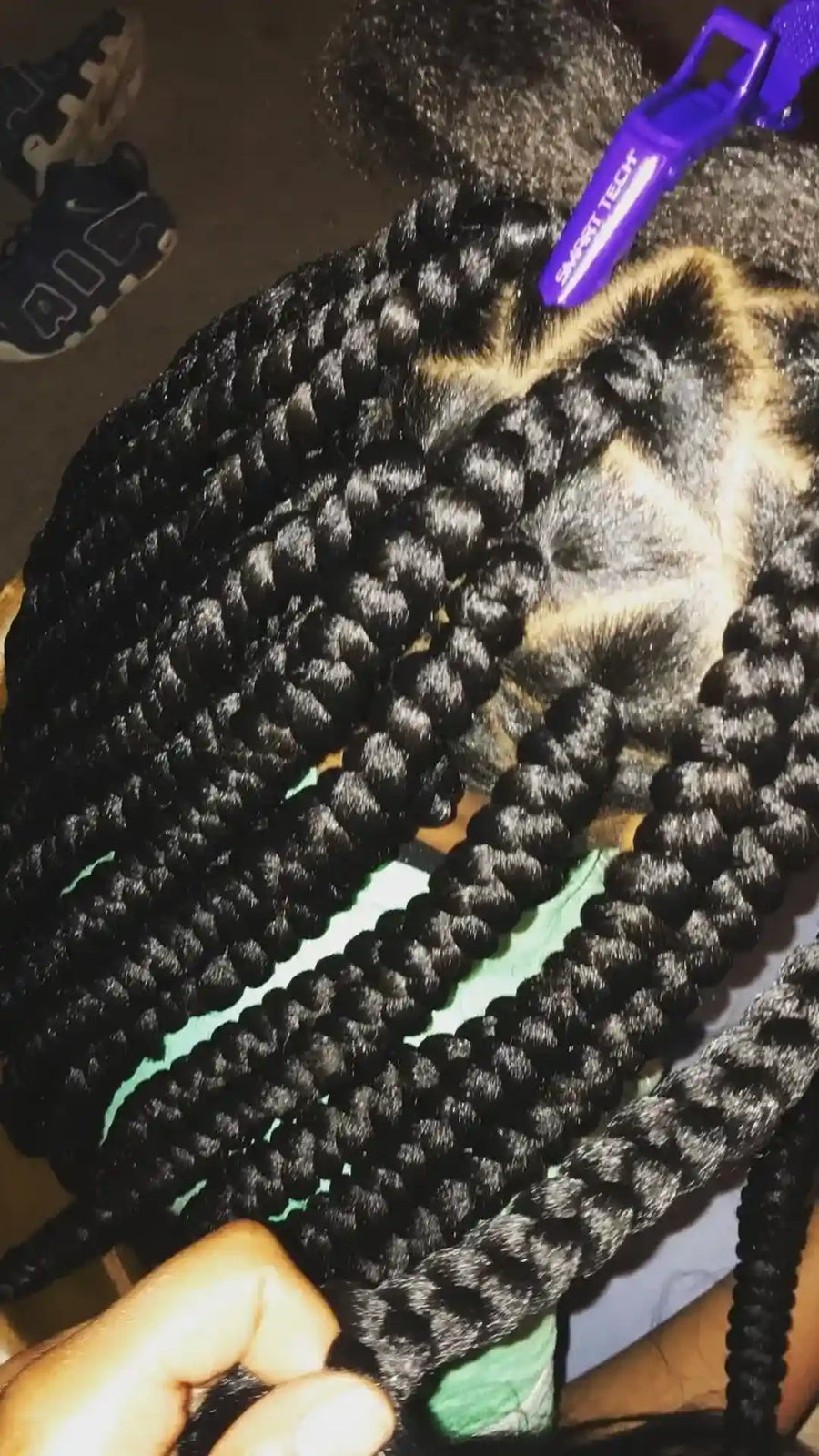 Close-up of jumbo black knotless box braids with large geometric sections, hairstylist located in Bettendorf, IA