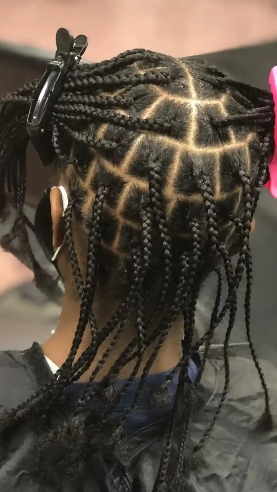 Small black knotless box braids with neat square and diamond parting, hairstylist located in Bettendorf, IA