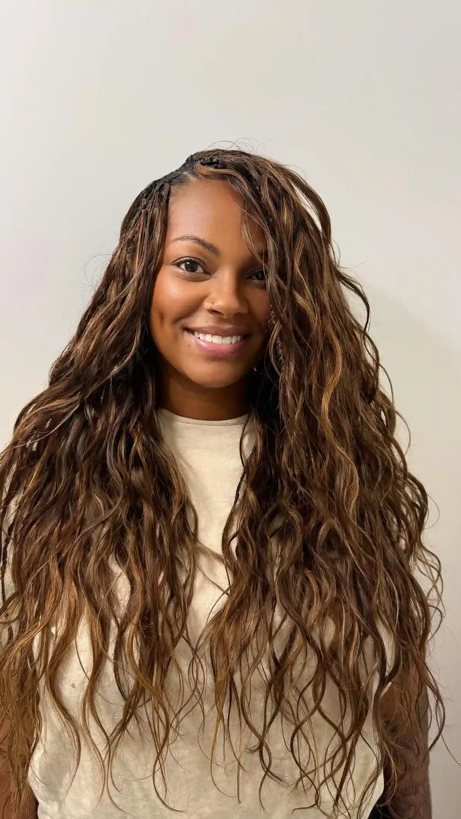 Long black and brown boho locs with loose curls and highlighted ends, hairstylist located in Jacksonville, FL
