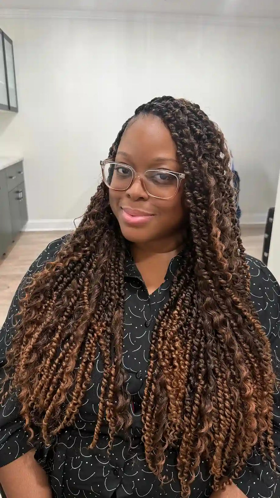 Extra-long copper brown boho braids with loose waves and decorative hair charms, hairstylist located in Jacksonville, FL