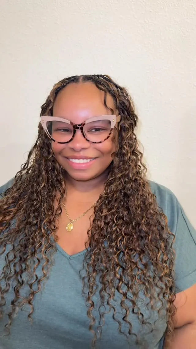 Long brown goddess braids with abundant loose curls and a center part, hairstylist located in Jacksonville, FL