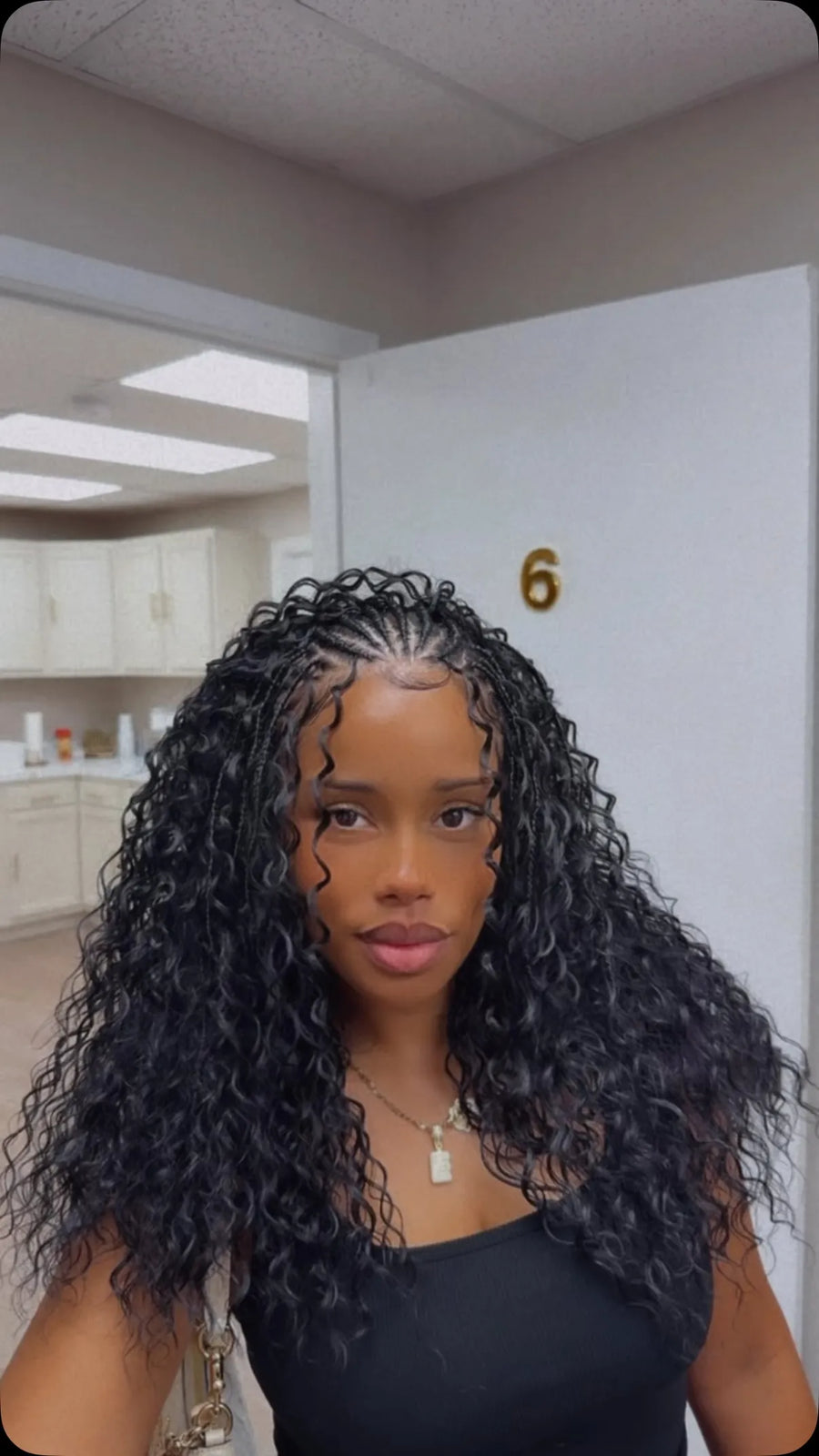 Waist-length black goddess braids with flowing waves and face-framing curls, hairstylist located in Jacksonville, FL