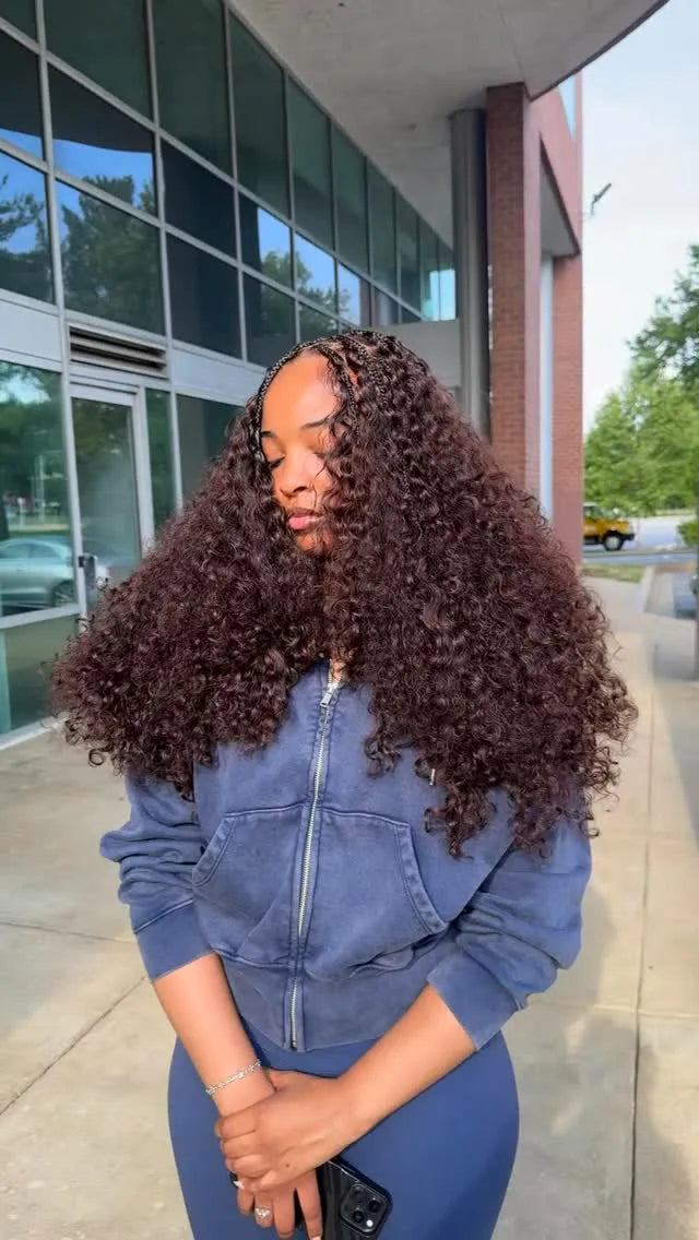 Extra-long black curly crochet hairstyle with small braided sections and full textured curls, hairstylist located in Lanham, MD