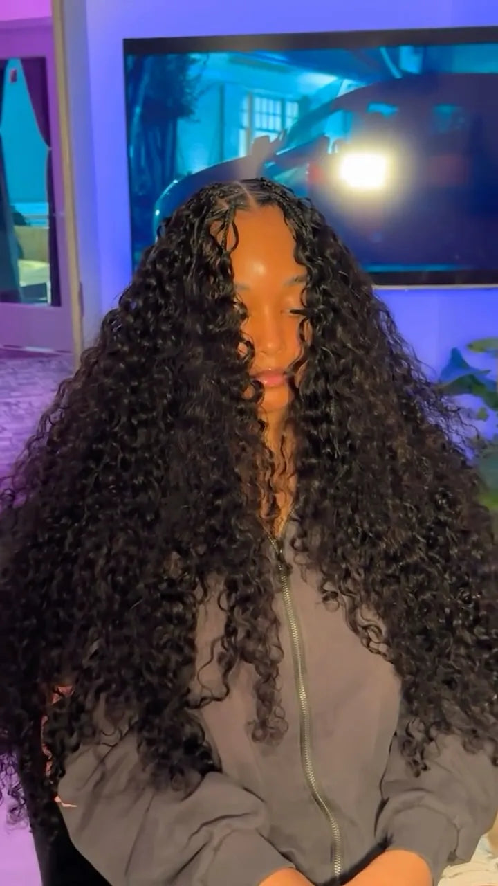 Extra-long voluminous curly crochet hairstyle with a center part and defined black curls, hairstylist located in Lanham, MD