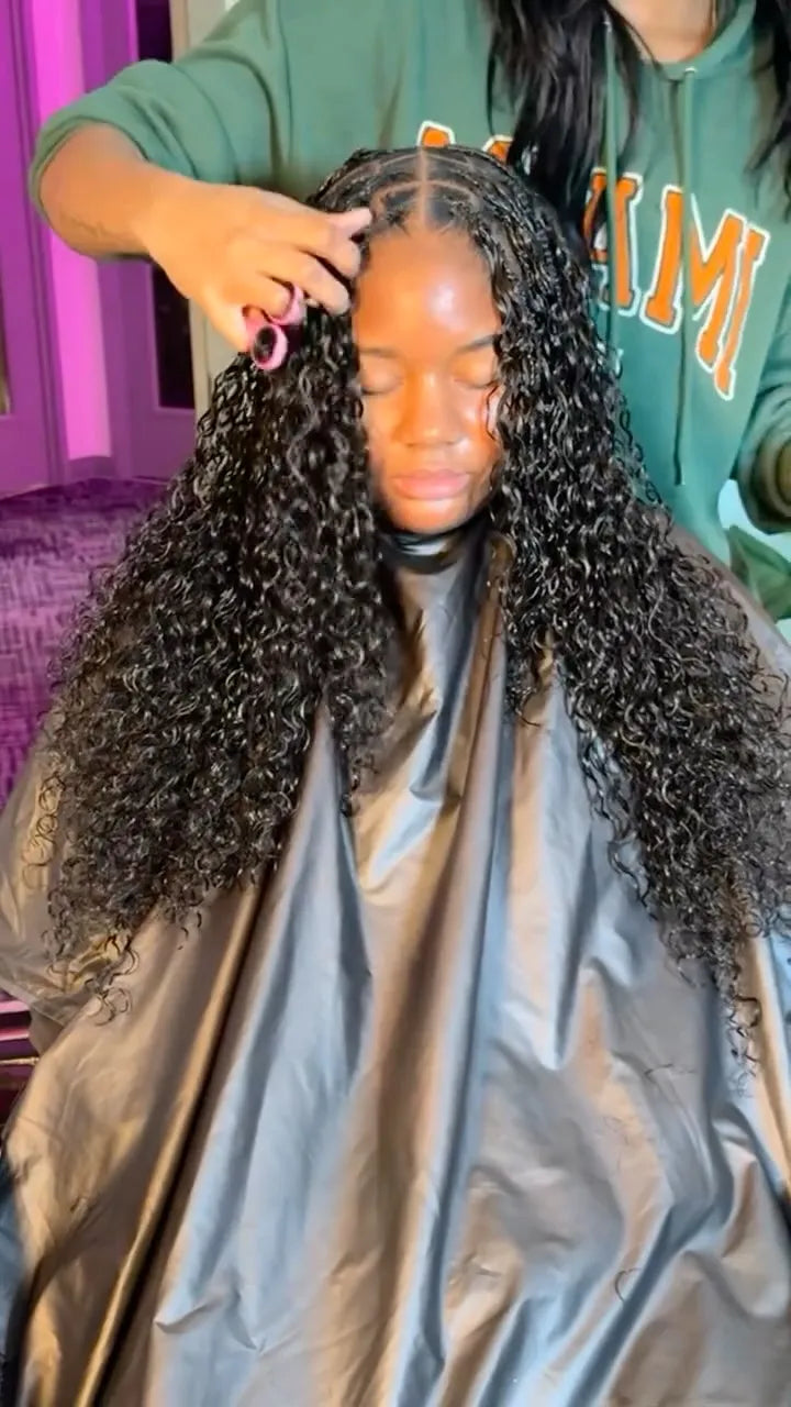 Long curly miracle knot hairstyle with center-parted cornrows and voluminous black curls, hairstylist located in Lanham, MD