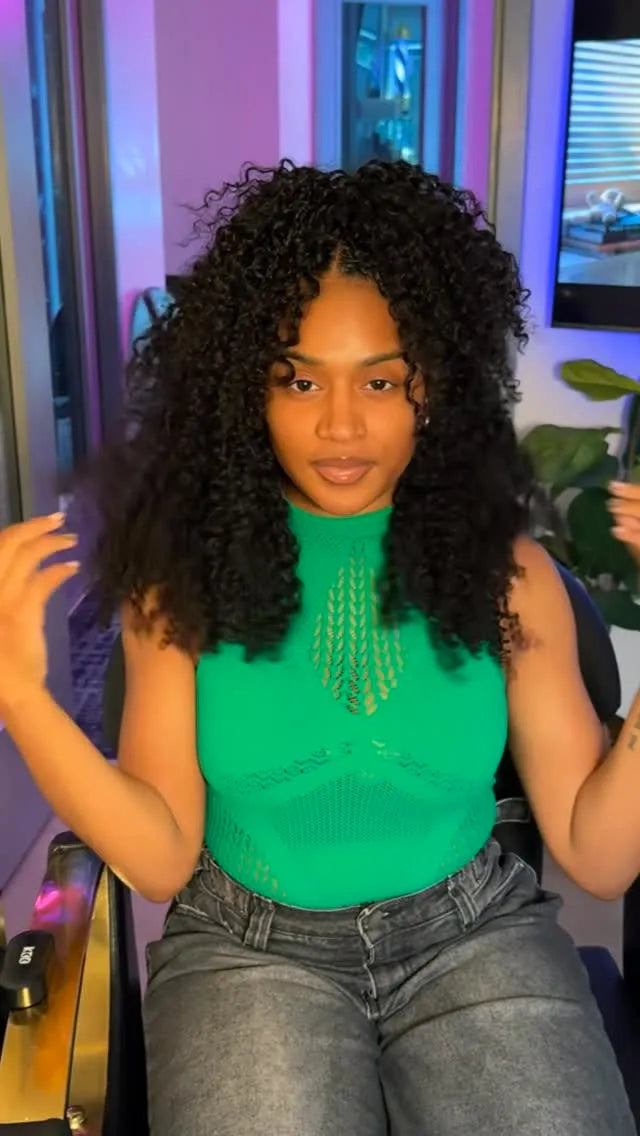 Shoulder-length natural curly crochet hairstyle with a center part and layered volume, hairstylist located in Lanham, MD
