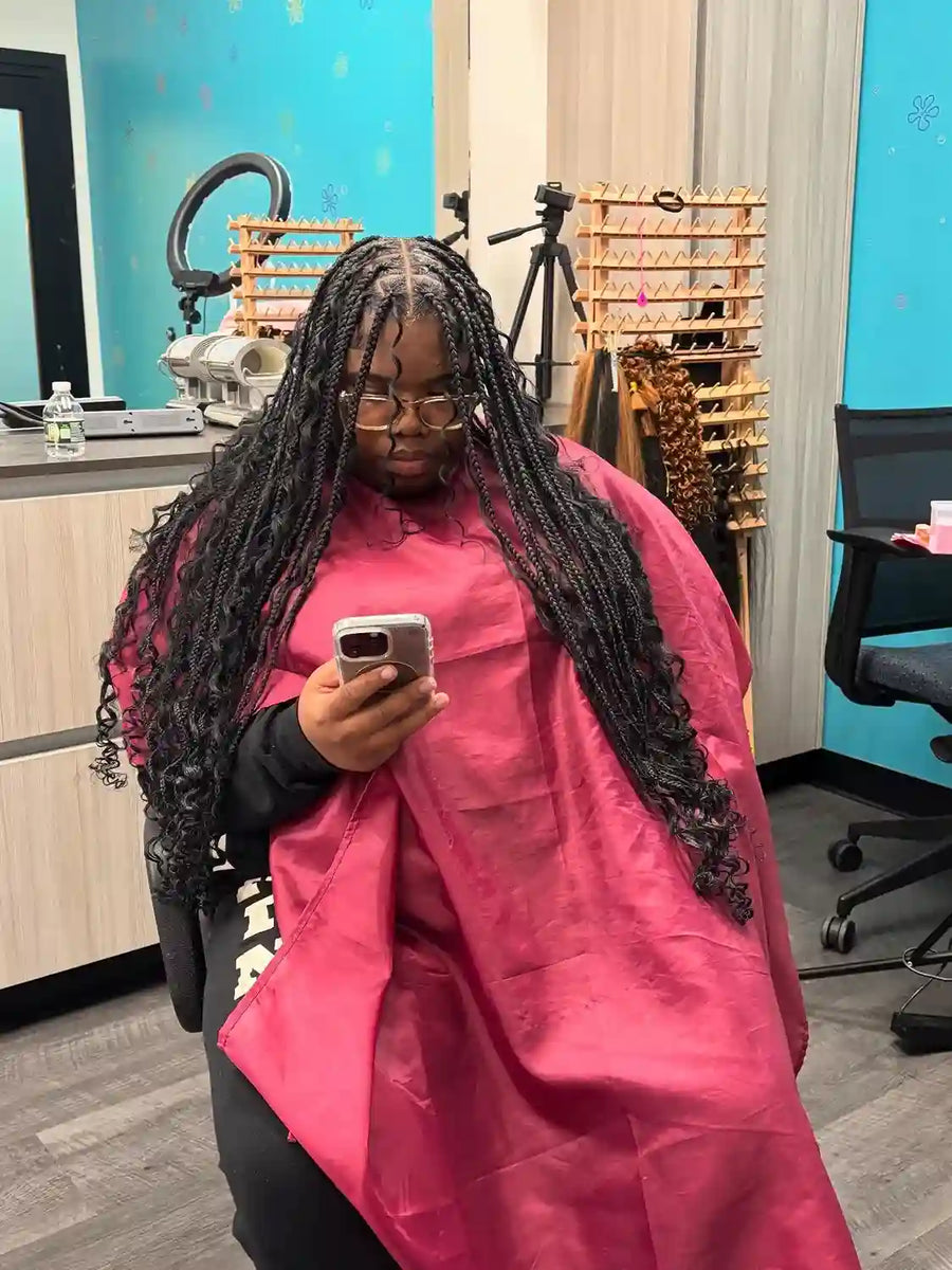 Long boho braids with loose curls and black protective style, hairstylist in Buffalo, NY
