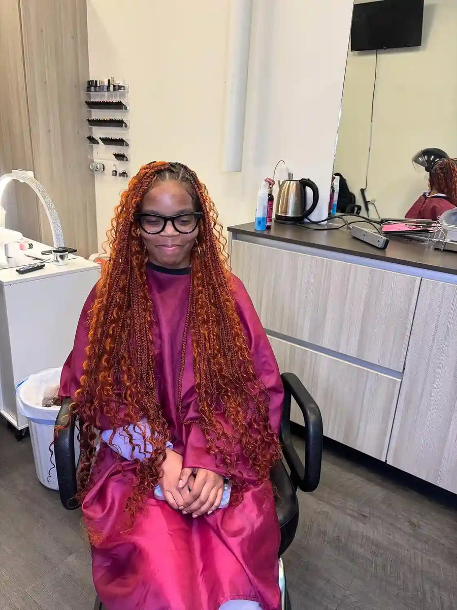 Long black boho braids with curly ends and full volume, hairstylist in Buffalo, NY