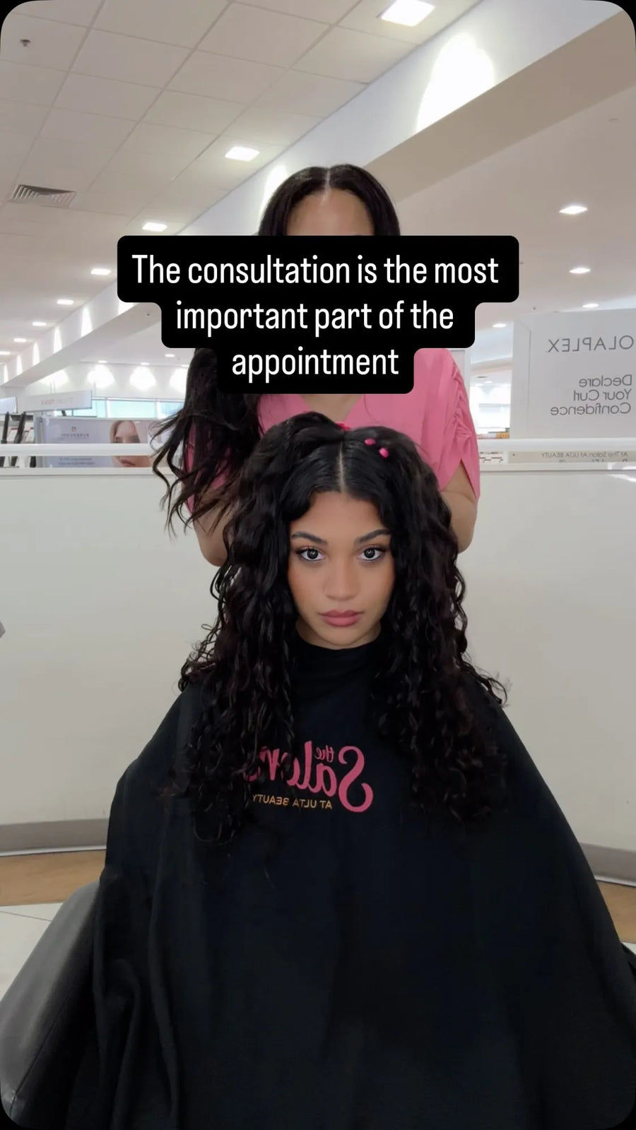 Long dark brown curly hairstyle with a center part, soft layers, and loose defined curls, Stylist located in Gilbert, AZ