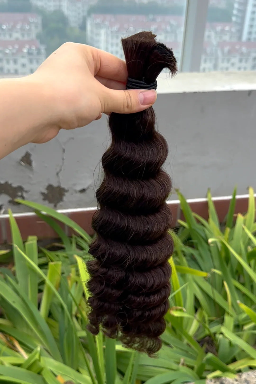 Outdoor image of the dark brown deep wave bulk human hair for braiding