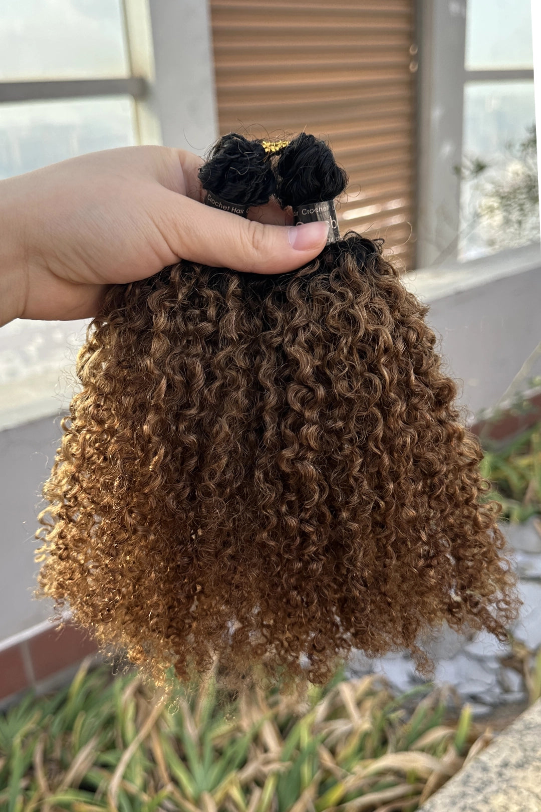 Outdoor picture of 1b30 two tone color tight curly feather crochet human hair