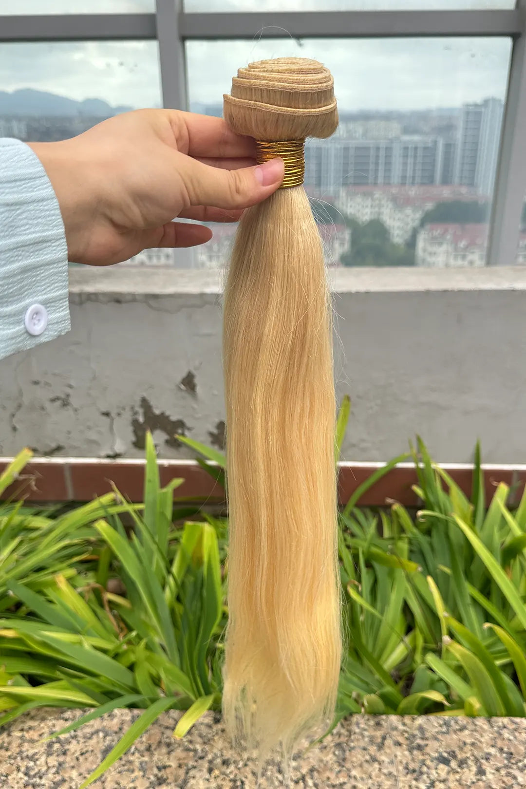 Outdoor picture of 613 blonde bundles double weft sew in extensions straight virgin hair