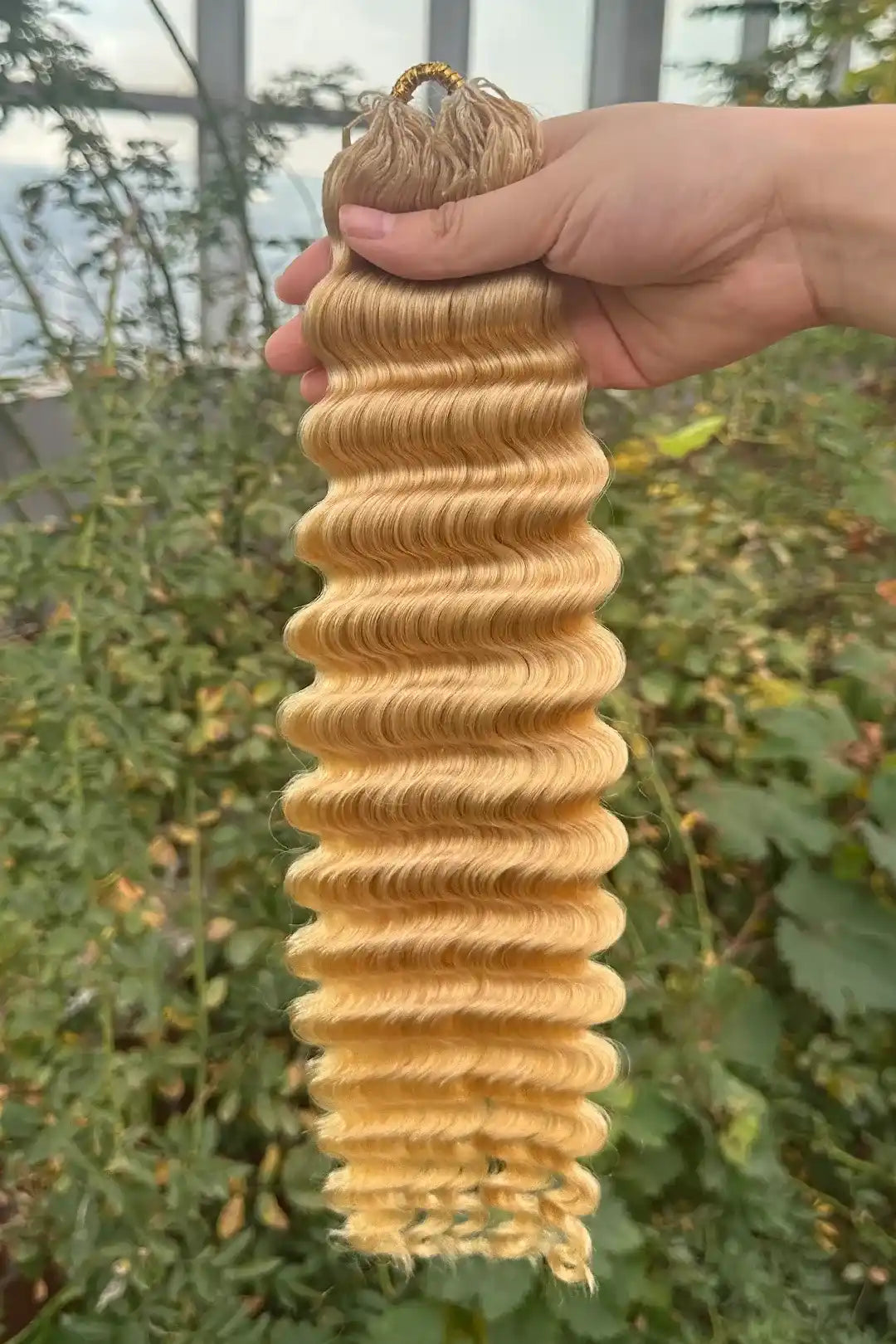 Outdoor picture of 613 blonde deep wave feather crochet miracle knots human hair