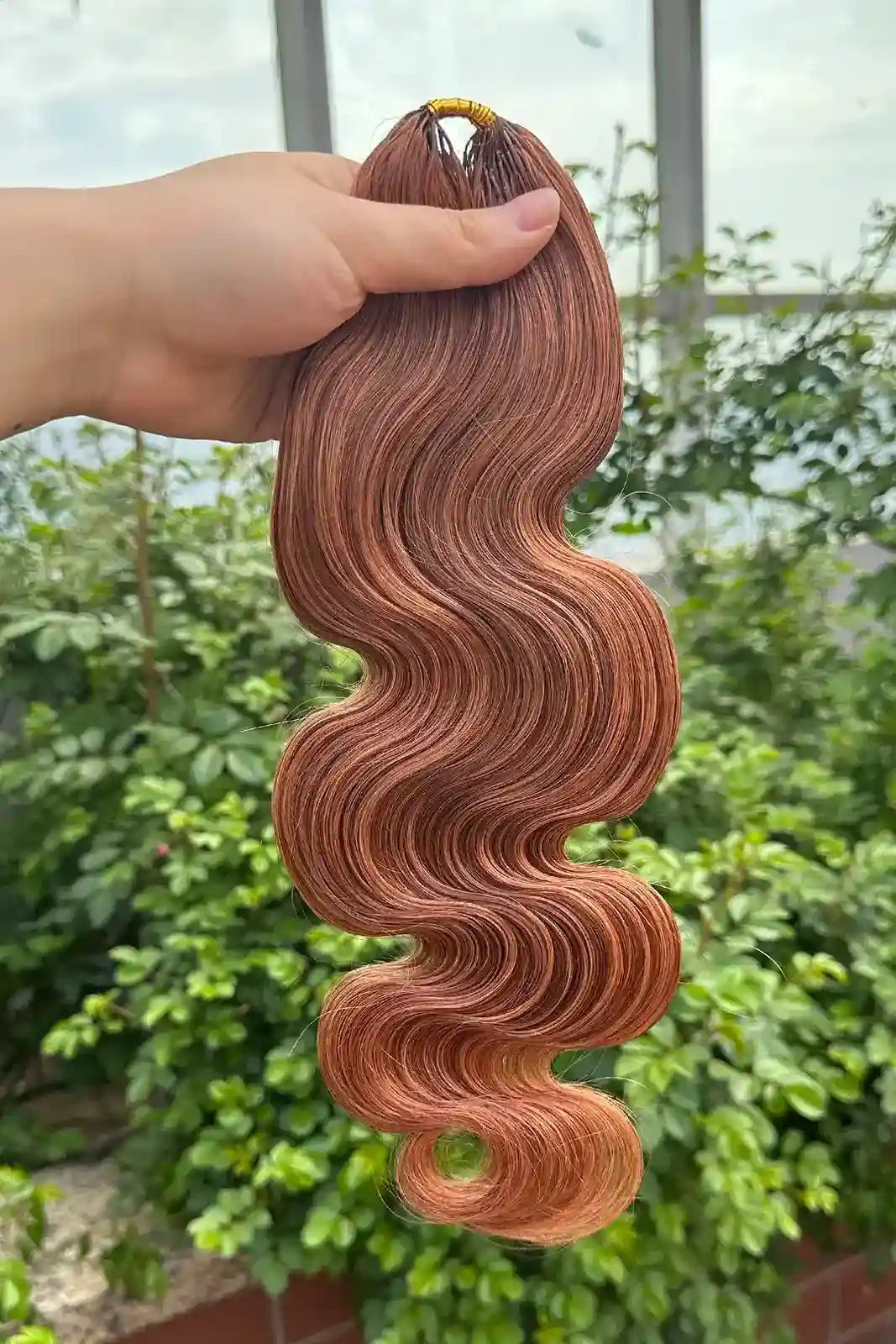 Outdoor picture of auburn brown 30 body wave feather crochet human hair miracle knots