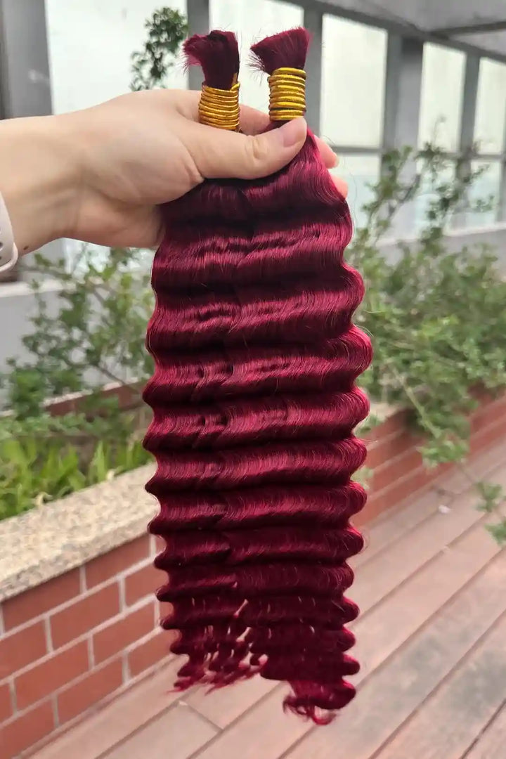 Outdoor picture of the ends of bulk human hair for braiding burgundy red deep wave bu19