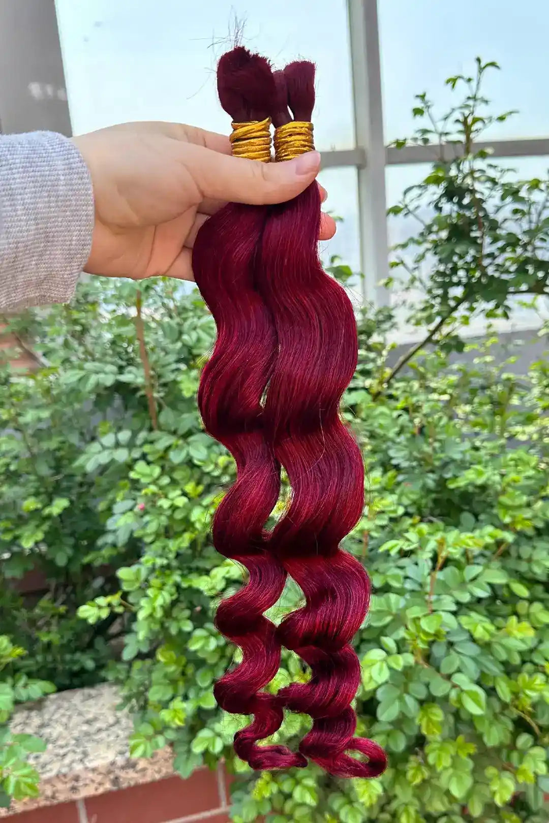 Outdoor picture of burgundy 99j loose wave bulk human hair for braiding 