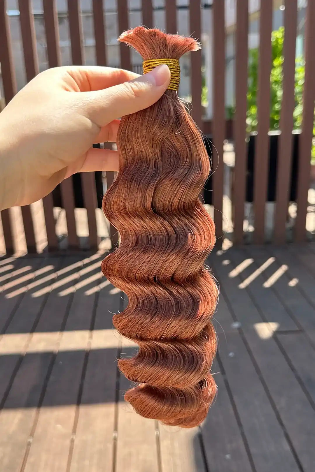 Outdoor picture of double drawn #30 medium auburn brown bulk hair loose wave BU66