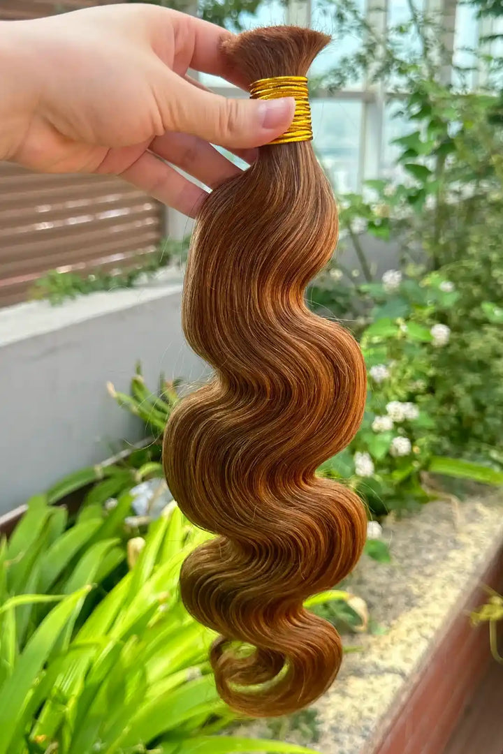 Outdoor picture of double drawn auburn brown body wave bulk hair bu60
