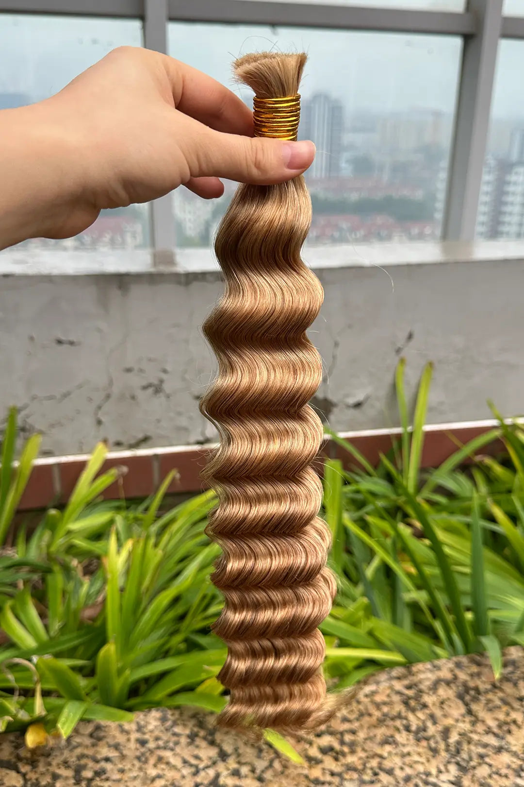 Outdoor picture of double drawn medium blonde bulk hair loose deep wave bu38