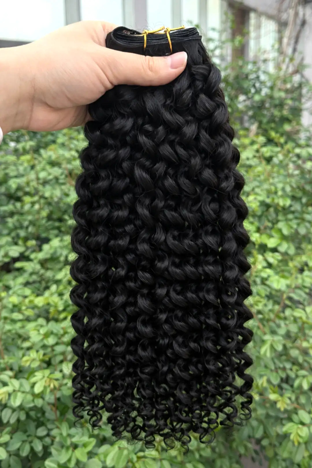 Outdoor picture of genius weft hair extensions water wave black virgin hair