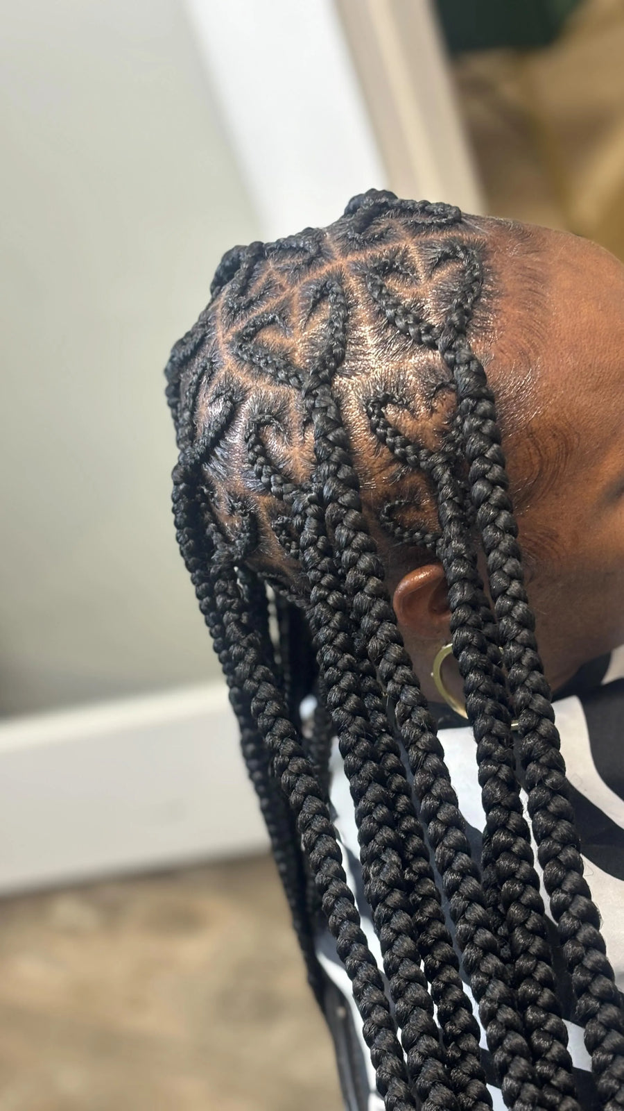 Large feed-in braids with curved part design, hairstylist in Westland, MI