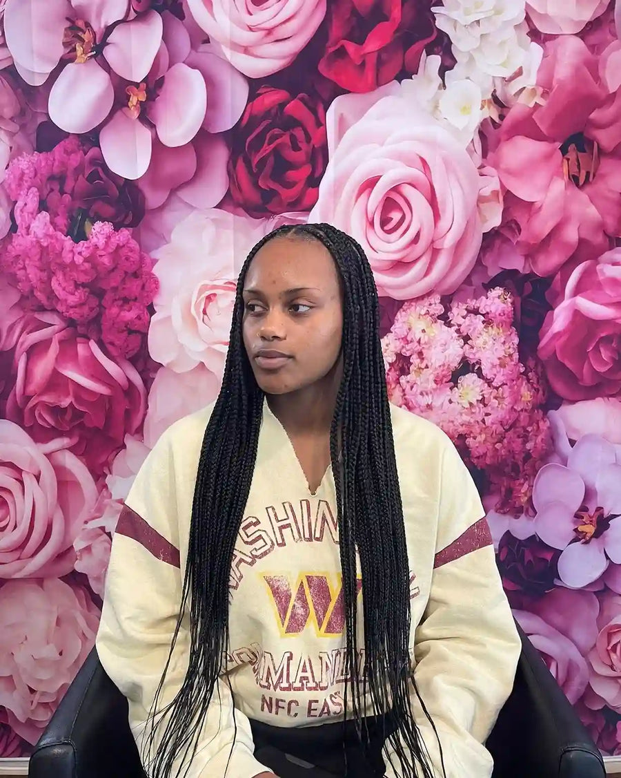 Shoulder length knotless braids with curly ends, hairstylist located in Round Rock, TX
