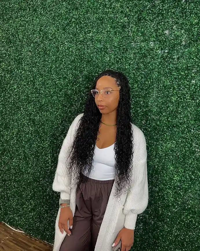 Long curly crochet hairstyle with middle part and defined curls, hairstylist located in Round Rock, TX