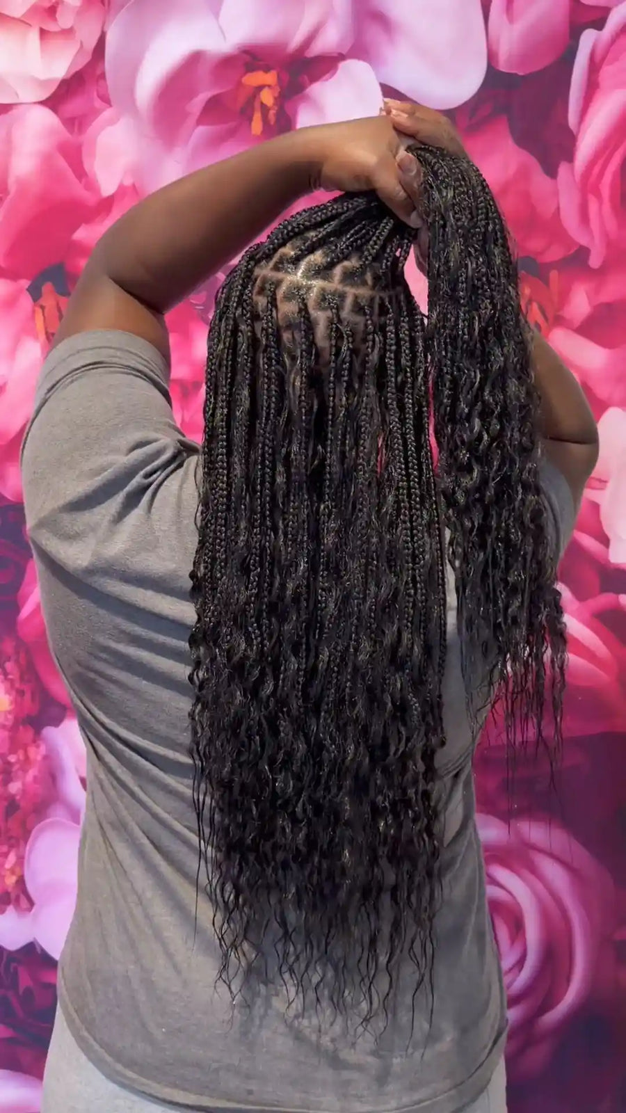 Boho knotless braids with loose wavy curls and natural black color, hairstylist located in Round Rock, TX