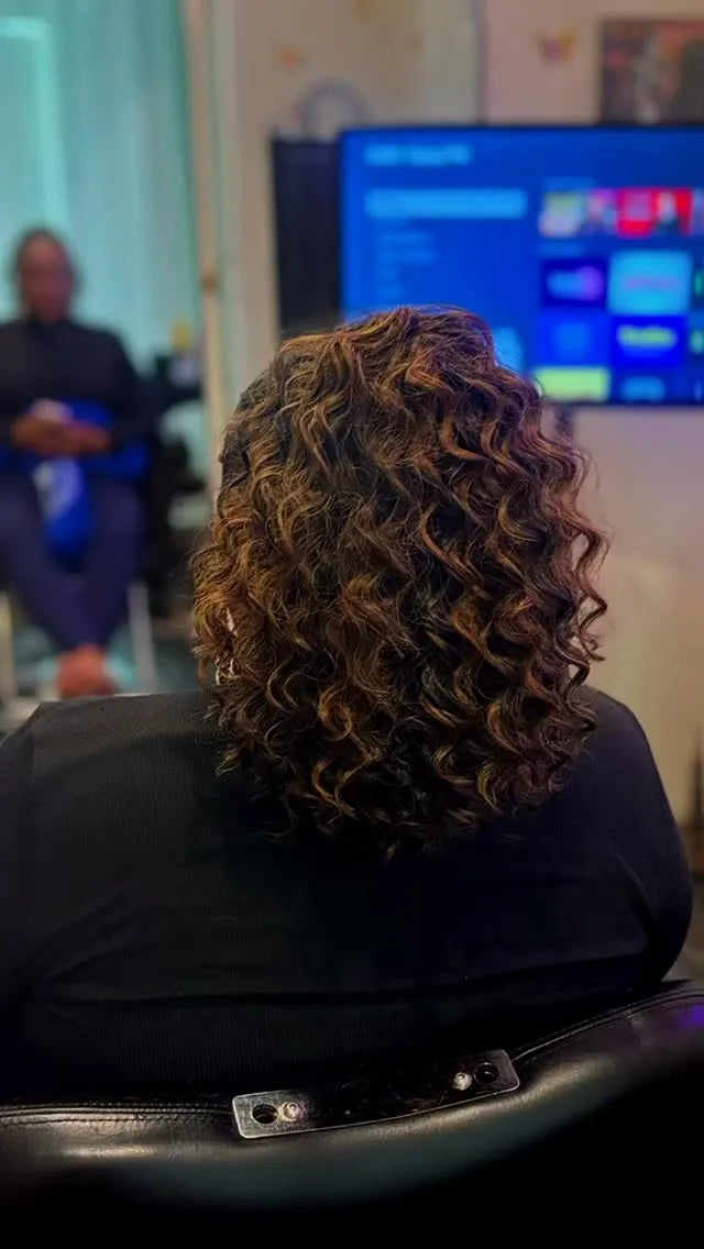 Shoulder-length curly hairstyle with brown highlights, hairstylist in Dover, DE