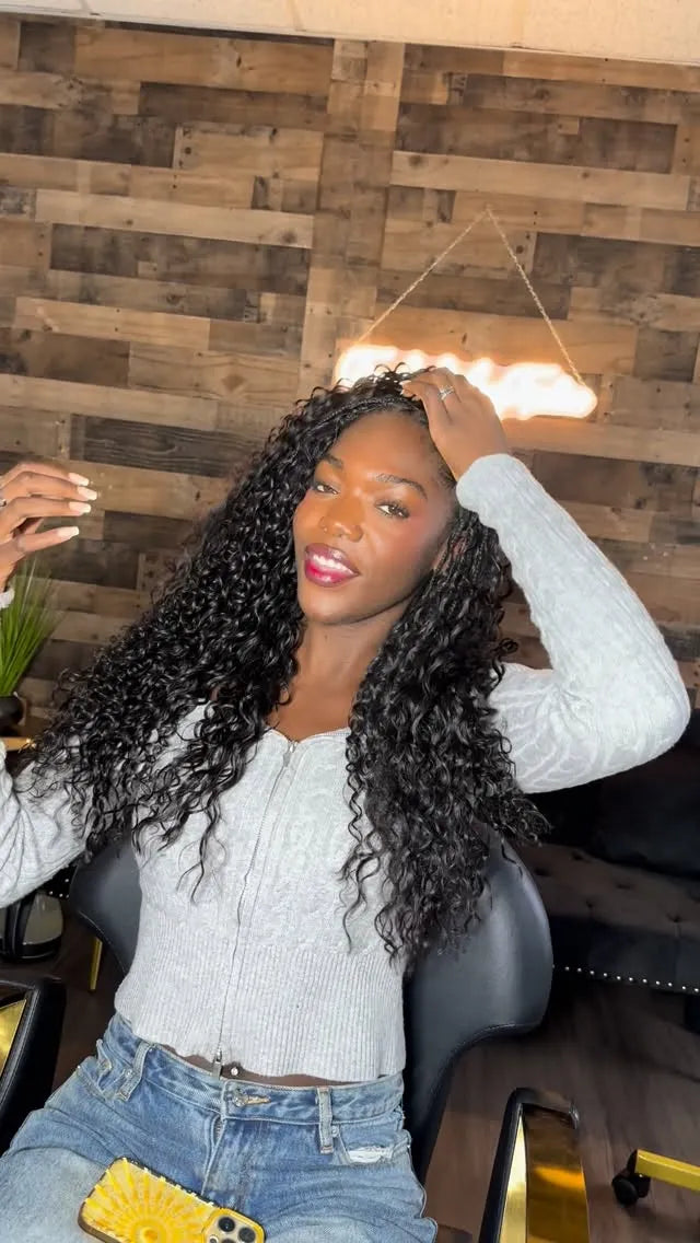Long black boho braids with loose curls and subtle blonde accent strands, hairstylist located in Fort Lauderdale, FL