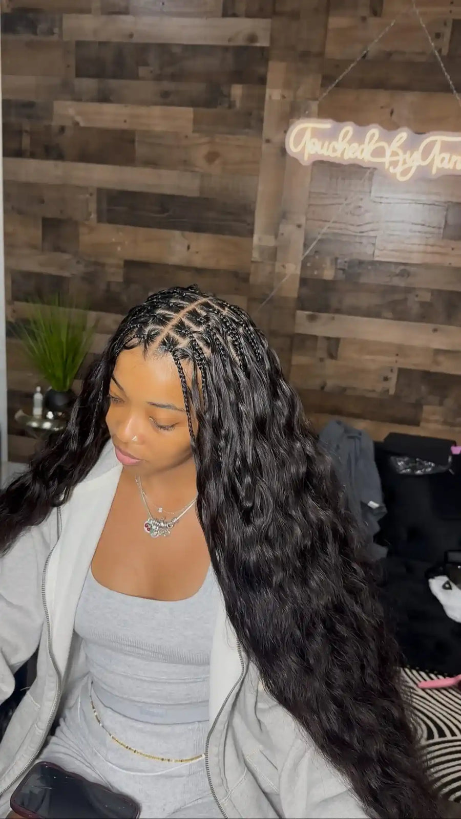 Fulani-style braids with geometric front sections and extra-long black body-wave extensions, hairstylist located in Fort Lauderdale, FL