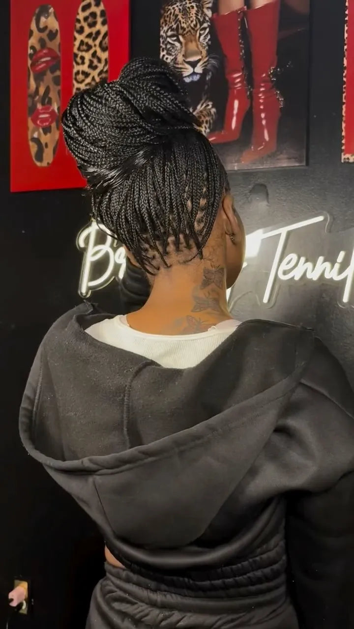Small box braids styled into a high braided bun, hairstylist in Dallas, TX