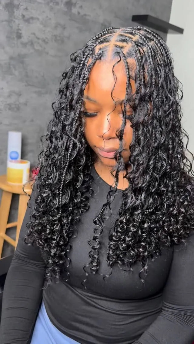 Shoulder-length black boho knotless braids with defined curls and a center part, hairstylist located in Elba, AL