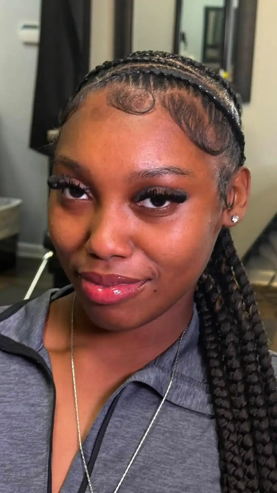 Sleek braided ponytail with straight-back cornrows and sculpted baby hairs, hairstylist located in Elba, AL