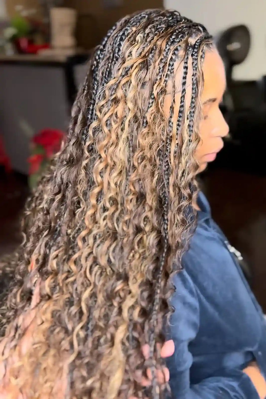 Person with long, braided hair in a side profile view.