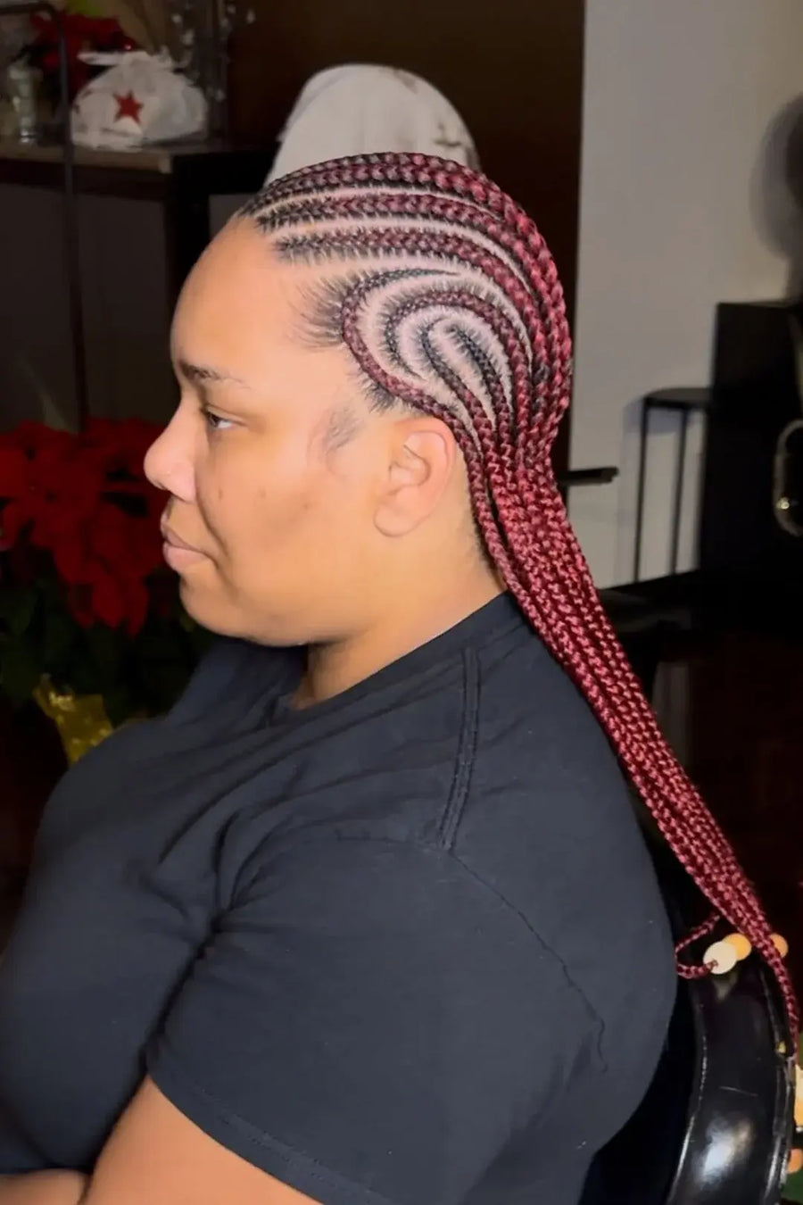 Person with braided hair in a salon setting