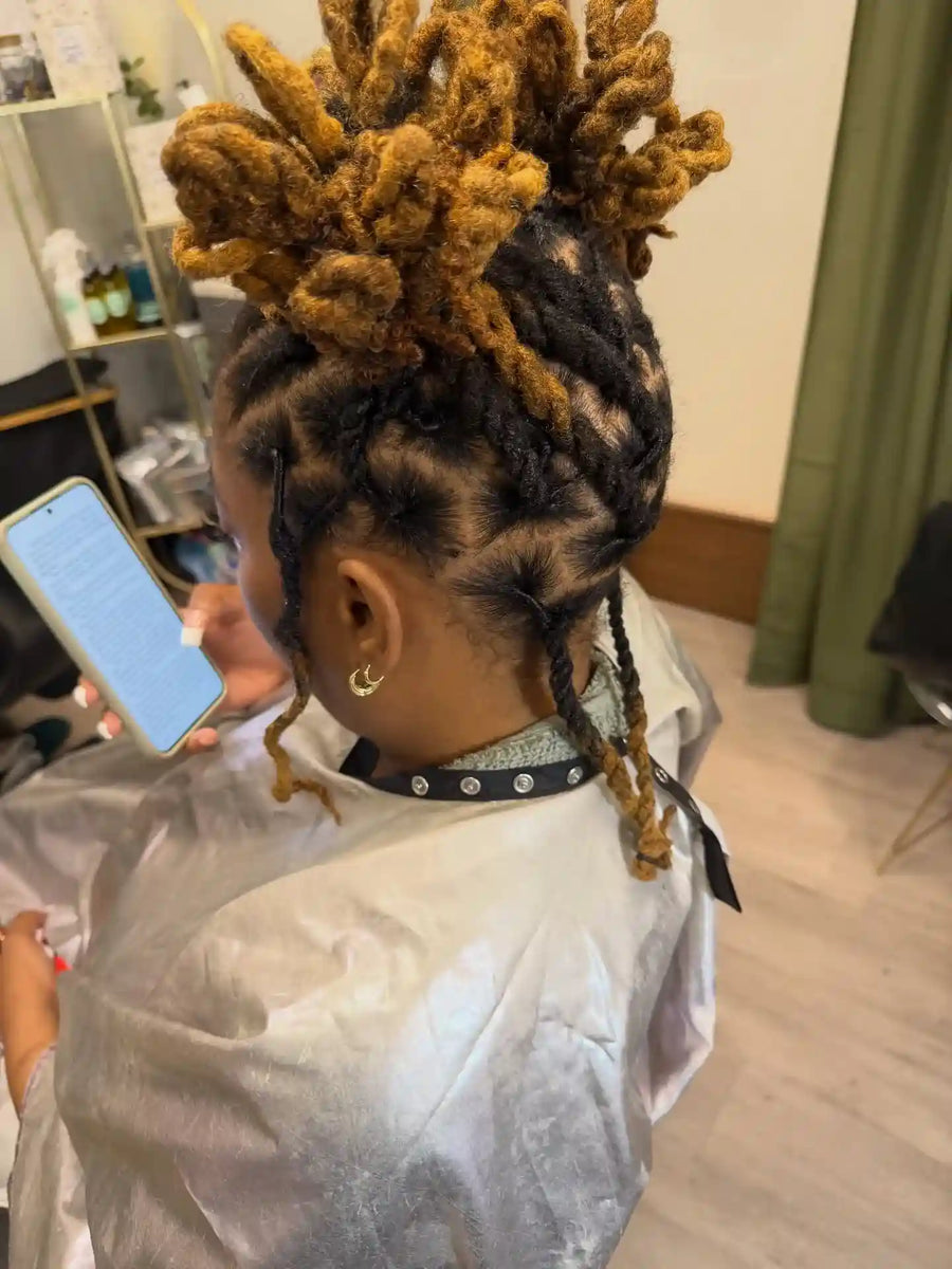Blonde loc updo with creative parting and twisted locs, Stylist located in Voorhees, NJ